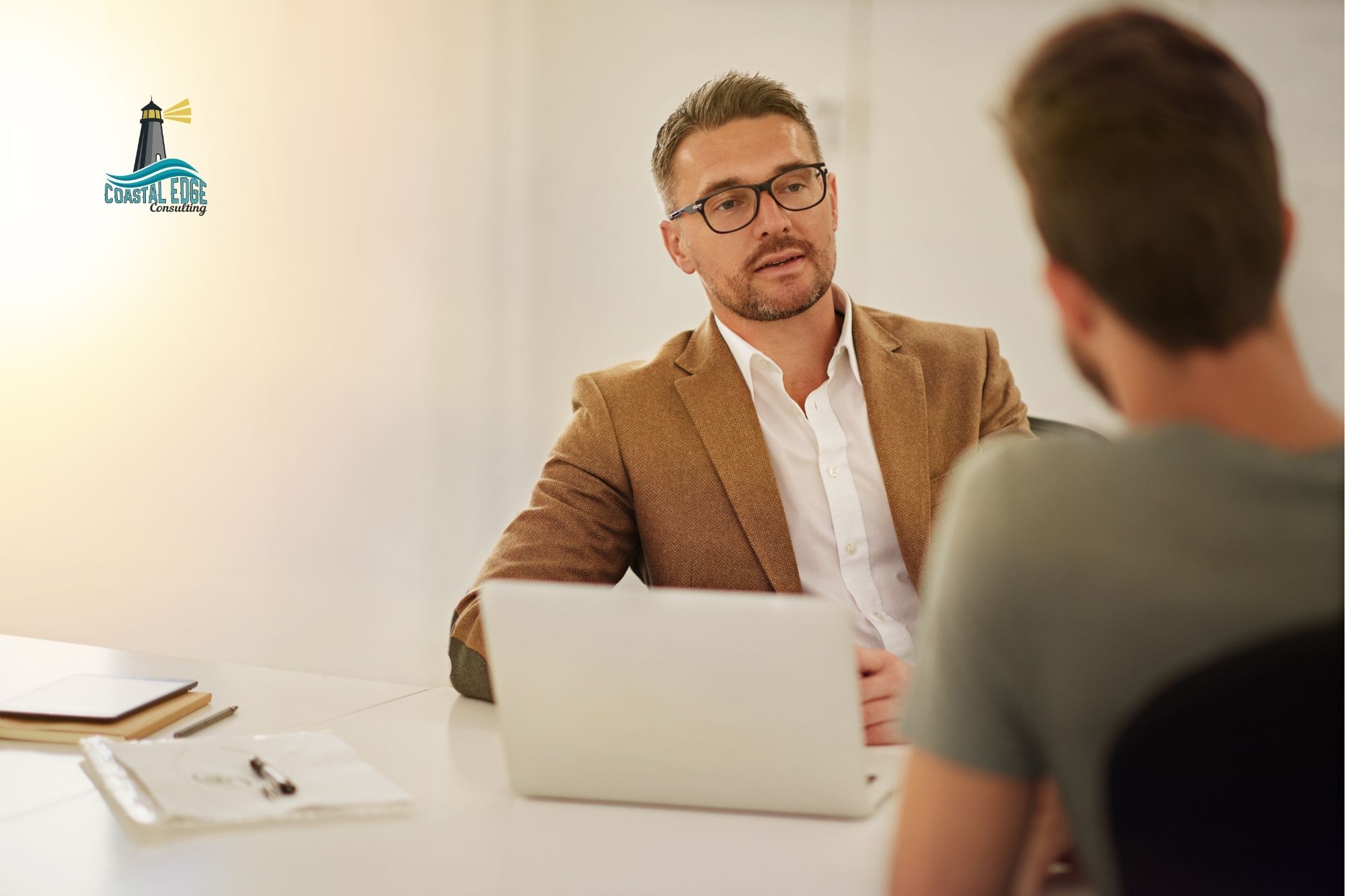 Leader sitting in front of employee in an office setting